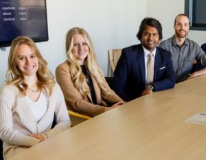 group of people sitting on chair in front of brown wooden table
